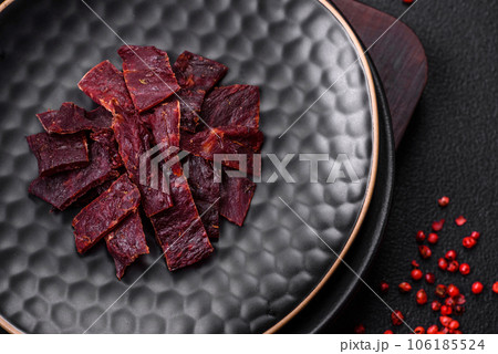 Delicious dried veal or turkey jerky with salt, spices and herbs 106185524