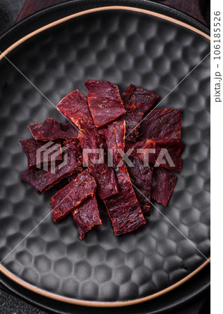 Delicious dried veal or turkey jerky with salt, spices and herbs Delicious dried veal or turkey jerky with salt, spices and herbs 106185526