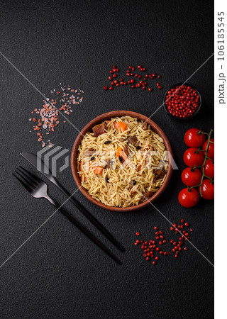 Delicious Uzbek pilaf with chicken, carrots, barberry, spices and herbs 106185545