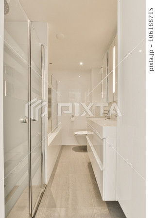a bathroom with white walls and wood flooring in the shower area, while there is no glass doors on the door 106188715