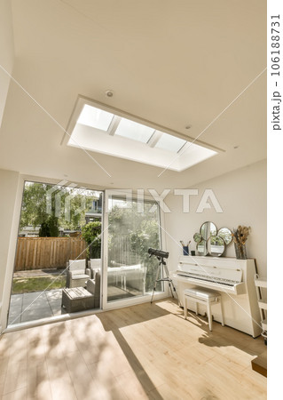 a living room with white furniture and an open door leading to the patio area that looks out onto the backyard a living room with white furniture and an open door leading to the patio area that looks out onto the backyard 106188731