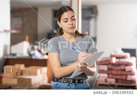Woman making notes on indoor construction site Woman making notes on indoor construction site 106190502