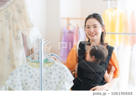 ショッピングモールでショッピングをする赤ちゃんを連れた若いお母さん ショッピングモールでショッピングをする赤ちゃんを連れた若いお母さん 106190888