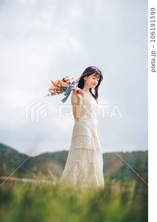 自然の中ブーケを持っている女性 106191599
