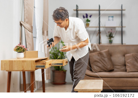 Senior man found his wallet that has forgotten in a drawer 106192172