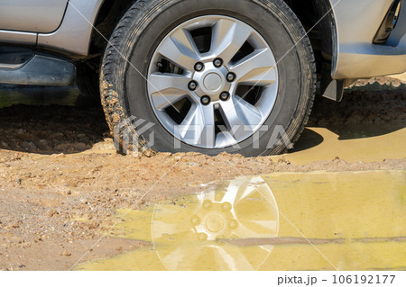 Suv 4wd car rides through muddy road 106192177