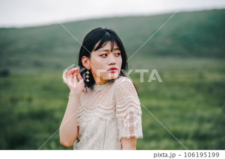 草原と白いワンピースの女性 106195199