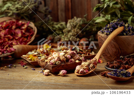 Various dried medicinal plants, herbs, and flowers on an old wooden background. Various dried medicinal plants, herbs, and flowers on an old wooden background. 106196433