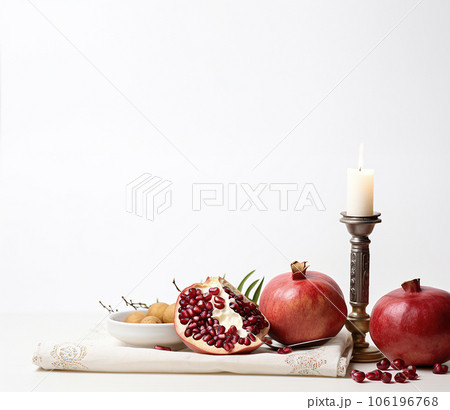Commemorating Jewish New Year with Fruits, Pomegranates, and Candlelight Commemorating Jewish New Year with Fruits, Pomegranates, and Candlelight 106196768