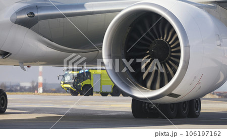 Fire truck of airport rescue and fire brigade behind airplane. 106197162