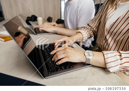 Female hands on black laptop keyboard close-up 106197330