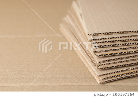 Corrugated cardboard on the table is laid out in layers. Corrugated cardboard on the table is laid out in layers. 106197364