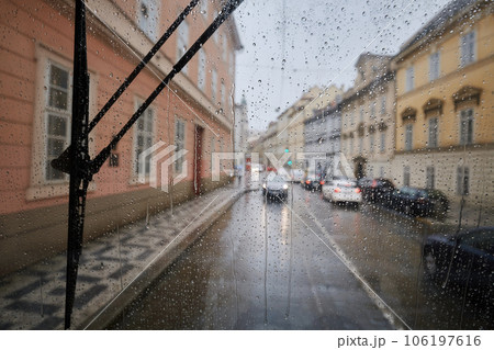 Raindrops on window of tram in city street. 106197616
