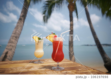 Two cocktails under palm trees on beautiful beach. 106197698