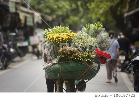 Street flower seller on bicycle in Hanoi. Street flower seller on bicycle in Hanoi. 106197722