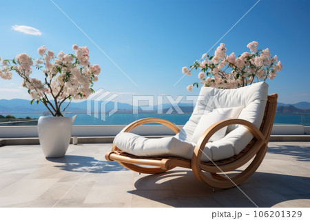 Summer vacation at poolside. Veranda decorated with deck chairs and umbrella with an ocean view 106201329