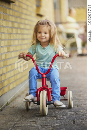 Charming blonde child rides a bicycle in Denmark 106203713