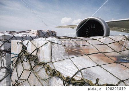 Loading of cargo containers against jet engine of plane. Loading of cargo containers against jet engine of plane. 106203859