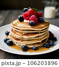 Pancakes with berries on a plate 106203896