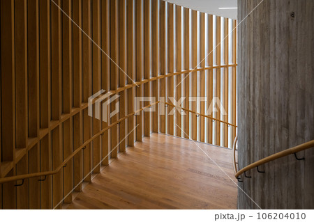 Railings made of wooden material placed on parquet floor surround and form empty small space under light Railings made of wooden material placed on parquet floor surround and form empty small space under light 106204010
