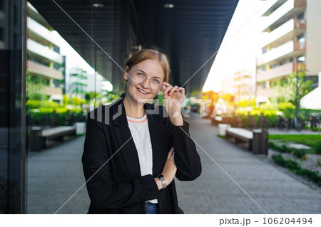 Young business woman wearing professional look smiling confident standing outside office buildings at the city  106204494