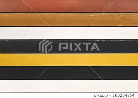 Multicolored wooden planks background. Backdrop made of brown, white, black and yellow planks arranged horizontally. Colorful wood backdrop. 106204954