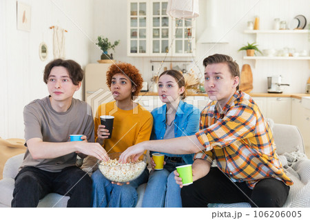 Group of friends watching sport match soccer football game on tv. Happy football fans celebrating victory at home. Friendship sports entertainment concept. Diverse buddies having fun together at home Group of friends watching sport match soccer football game on tv. Happy football fans celebrating victory at home. Friendship sports entertainment concept. Diverse buddies having fun together at home 106206005