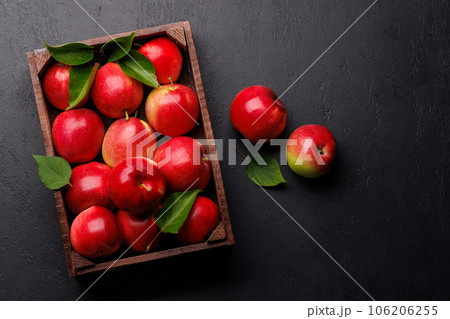 Wooden box with fresh red apples 106206255