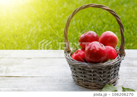 Basket with fresh red apples 106206270