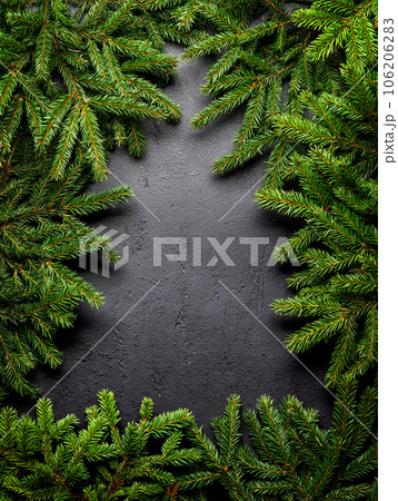 Christmas fir tree branch frame over stone Christmas fir tree branch frame over stone 106206283