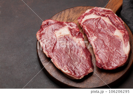 Two raw ribeye beef steaks Two raw ribeye beef steaks 106206295