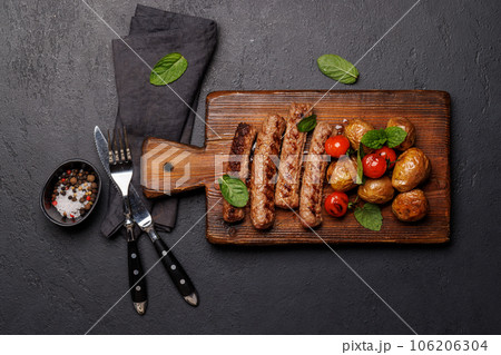 Delicious grilled sausages and potatoes 106206304