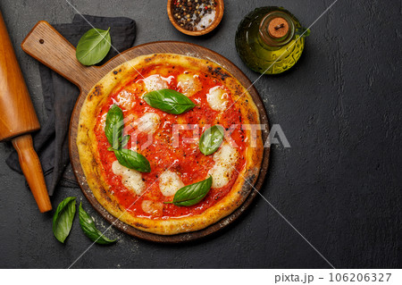 Margarita pizza with tomatoes, mozzarella cheese and basil Margarita pizza with tomatoes, mozzarella cheese and basil 106206327