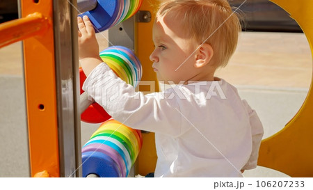 Cute baby learning how to use and play with colorful abacus. Children developments, kids education, baby learning. Cute baby learning how to use and play with colorful abacus. Children developments, kids education, baby learning. 106207233