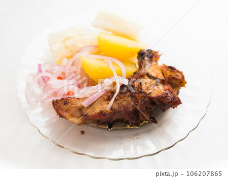 Dish of fried pork ribs, rice, potatoes, sweet potato and pickled onions Dish of fried pork ribs, rice, potatoes, sweet potato and pickled onions 106207865