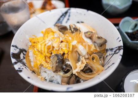 close-up of katsudon, a popular Japanese food at Enoshima island. The bowl is filled with rice, a deep-fried shell cutlet, egg, and onions 106208107