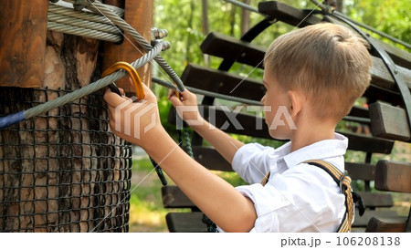 Portrait of little boy clamping his safety ropeの写真素材