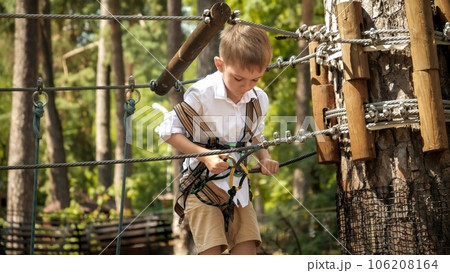 Little Boy Connecting His Safety Rope and Hook before Climbing Up