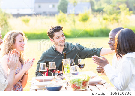 Joyful Gathering: Multiracial Friends Bond Over Food and Laughter 106210830