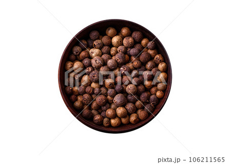 Spice allspice brown color not ground in a wooden saucer. Asian food Spice allspice brown color not ground in a wooden saucer. Asian food 106211565
