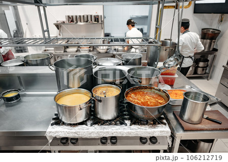 Food preparing in metal pots on the stove at professional kitchen Food preparing in metal pots on the stove at professional kitchen 106212719
