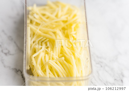 Shredded potato placed on a marble slab. Shredded potato placed on a marble slab. 106212997