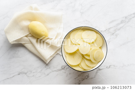 Potato and potato chips placed on a marble slab. 106213073