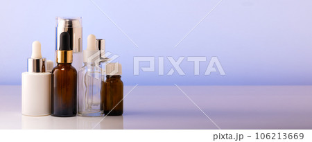 A lot of cosmetic bottles on a white table, an assortment of cosmetic bottles in the bathroom, healthy cosmetology, spa concept, copy space 106213669