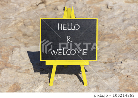Hello and welcome symbol. Concept words Hello and welcome on black chalk blackboard on a beautiful stone background. Business hello and welcome concept. Copy space. 106214865