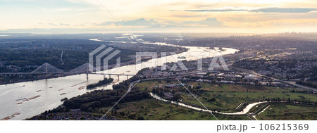 Aerial View of Fraser River and City. Cloudy Sunset Sky. Panorama. Pitt Meadows, Vancouver, BC, Canada Aerial View of Fraser River and City. Cloudy Sunset Sky. Panorama. Pitt Meadows, Vancouver, BC, Canada 106215369