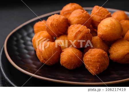 Delicious fried potato balls with breaded mozzarella, salt, spices and herbs 106217419