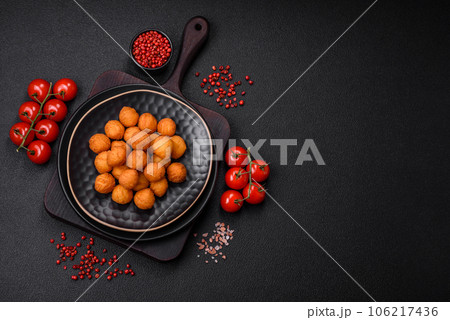 Delicious fried potato balls with breaded mozzarella, salt, spices and herbs 106217436