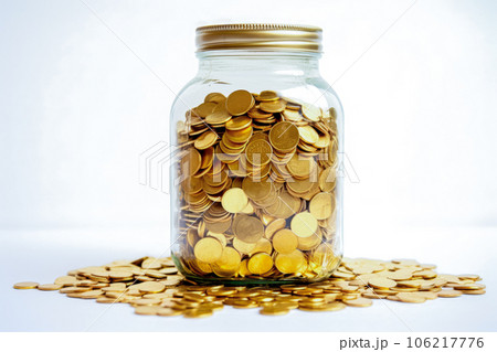 Coins spilling out of a glass jar on a white background Coins spilling out of a glass jar on a white background 106217776