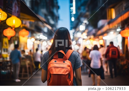 Back view of asian woman tourist with backpack walking on street at night Back view of asian woman tourist with backpack walking on street at night 106217933